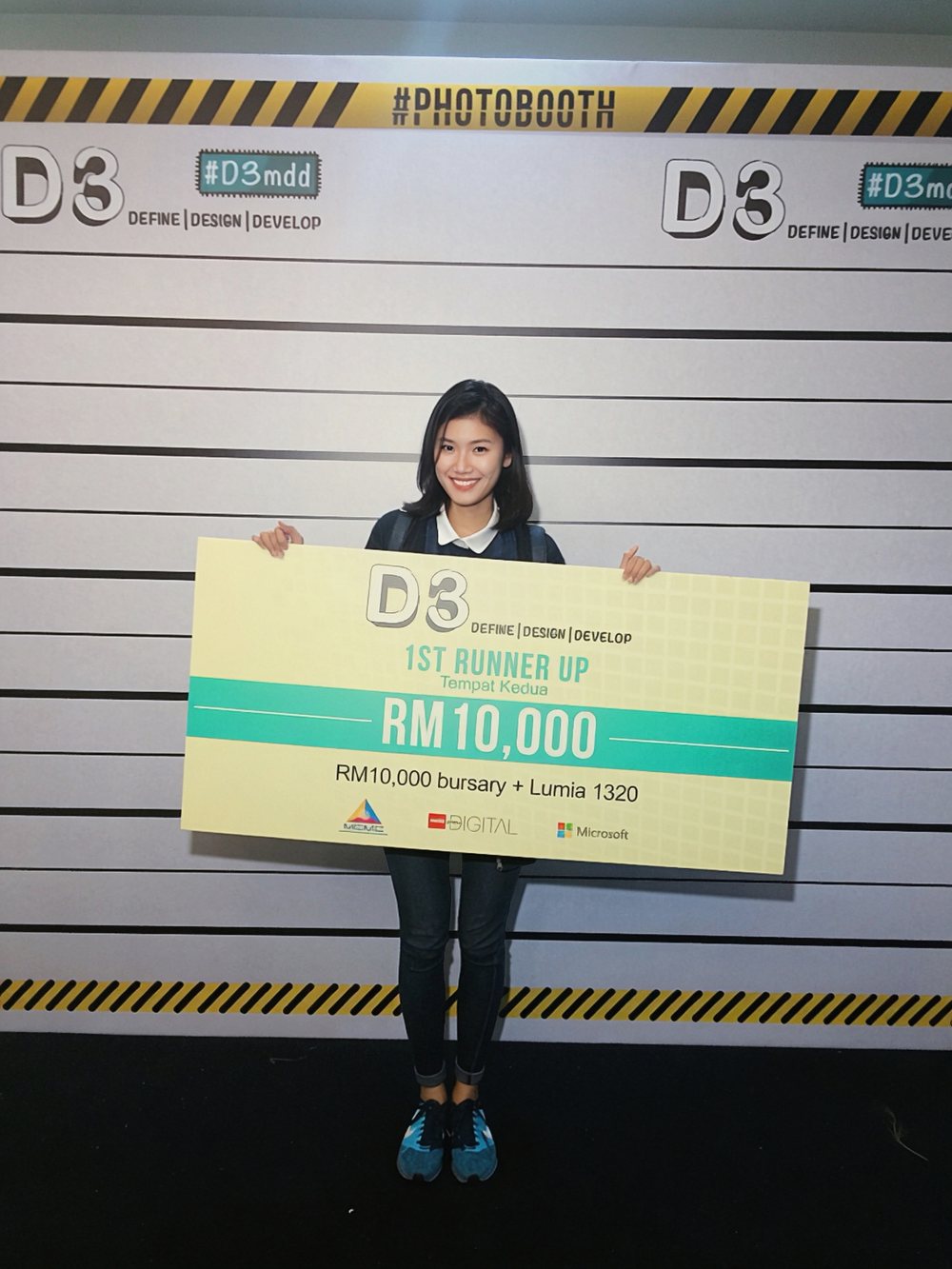 Raeesa Sya holding an oversized cheque for RM10,000 as first runner up at the D3 Define Design Develop competition.